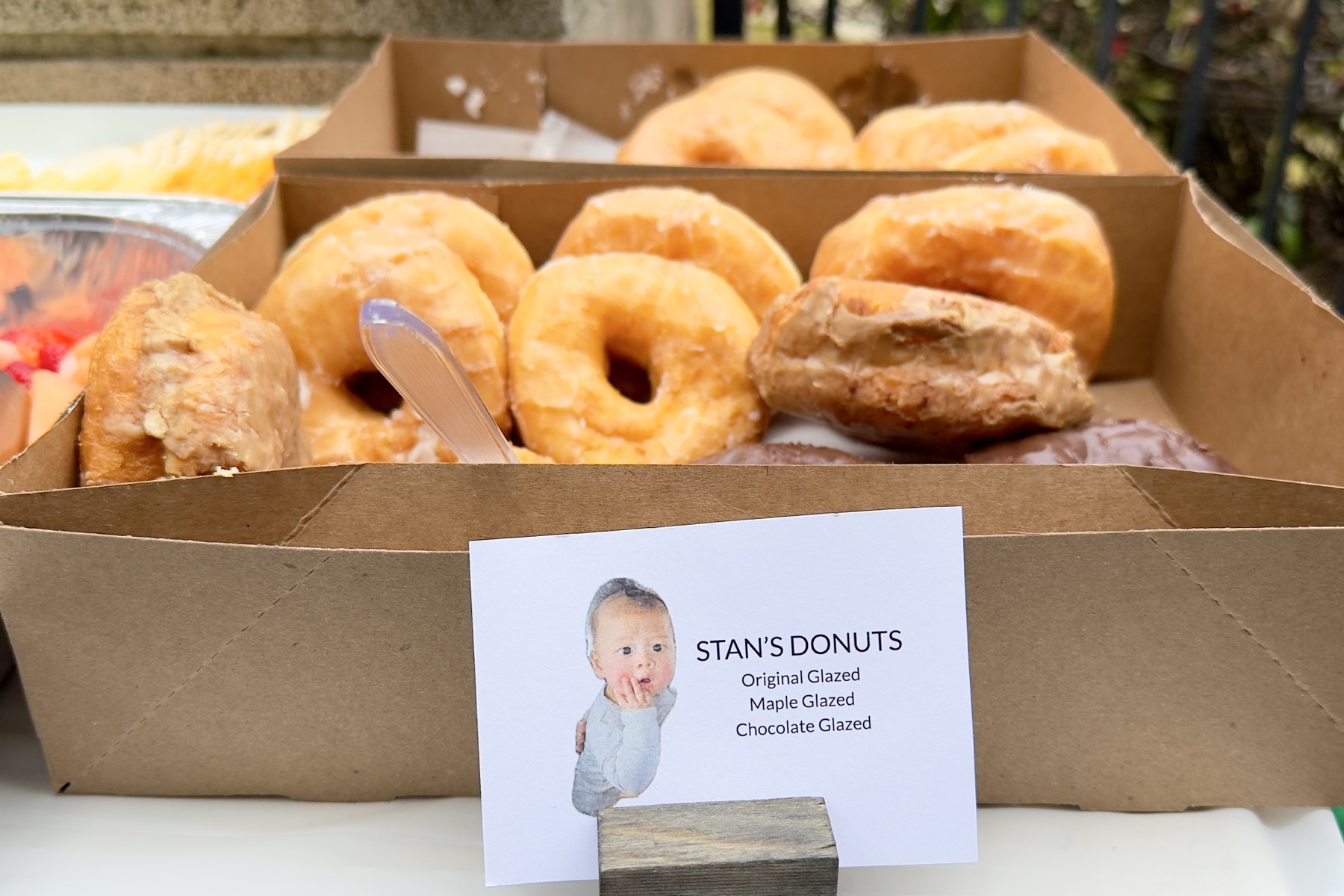 Canonical donuts and a sign listing the flavors.